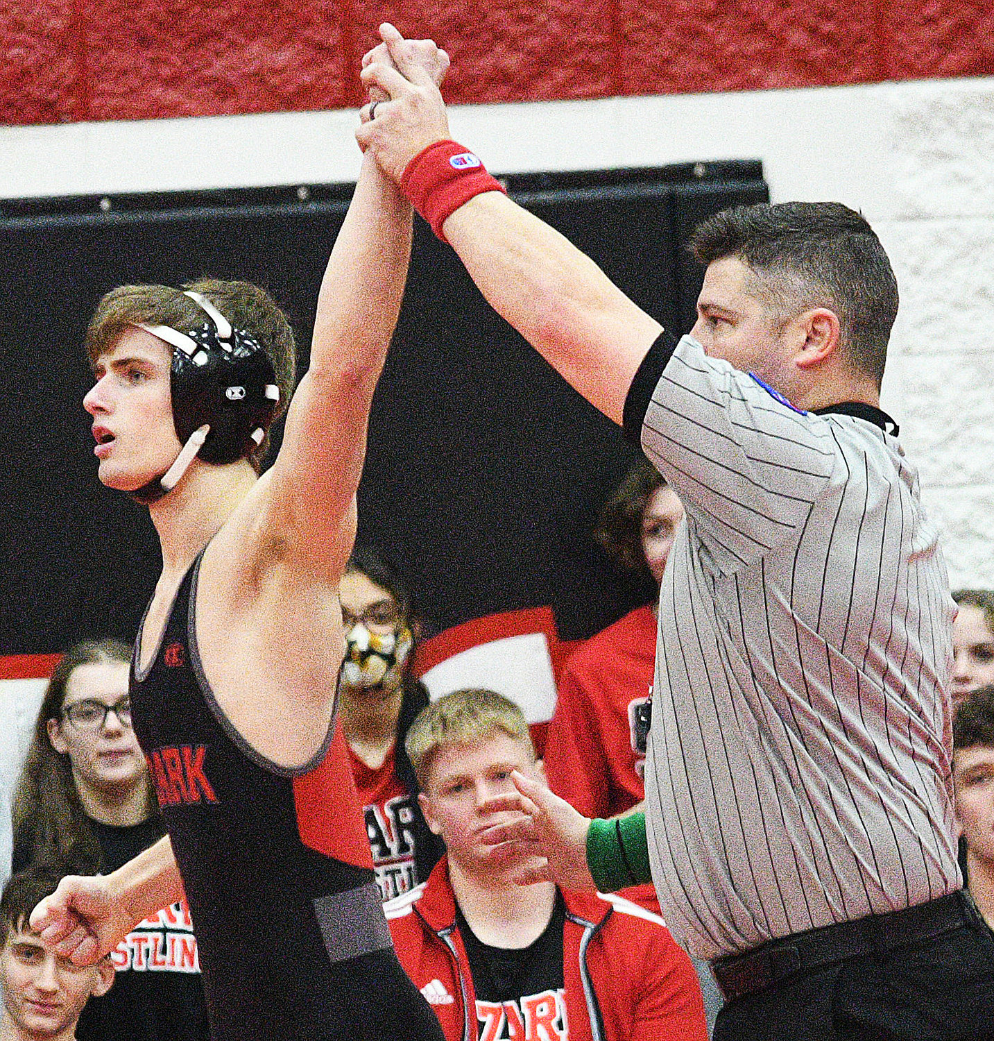 LEVI MASKROD has his arm raised in victory at 132.