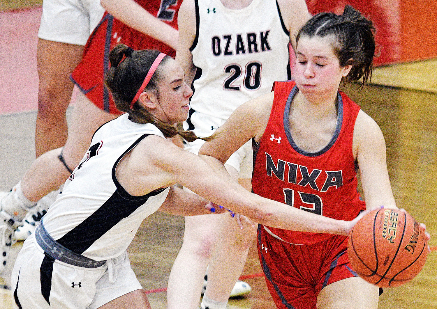 OZARK’S RILEY BOGGS collects a steal in the Lady Tigers’ home contest with Nixa on Monday.