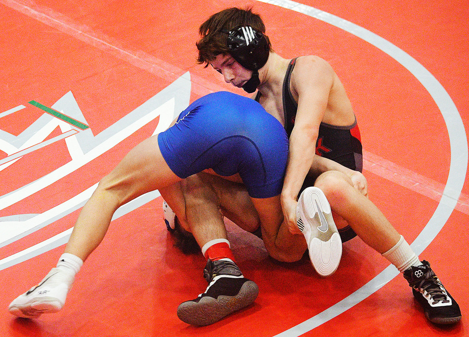 OZARK’S CADEN HARRINGTON works his way toward a 7-5 overtime victory in a Class 4 District 3 quarterfinal match Friday.