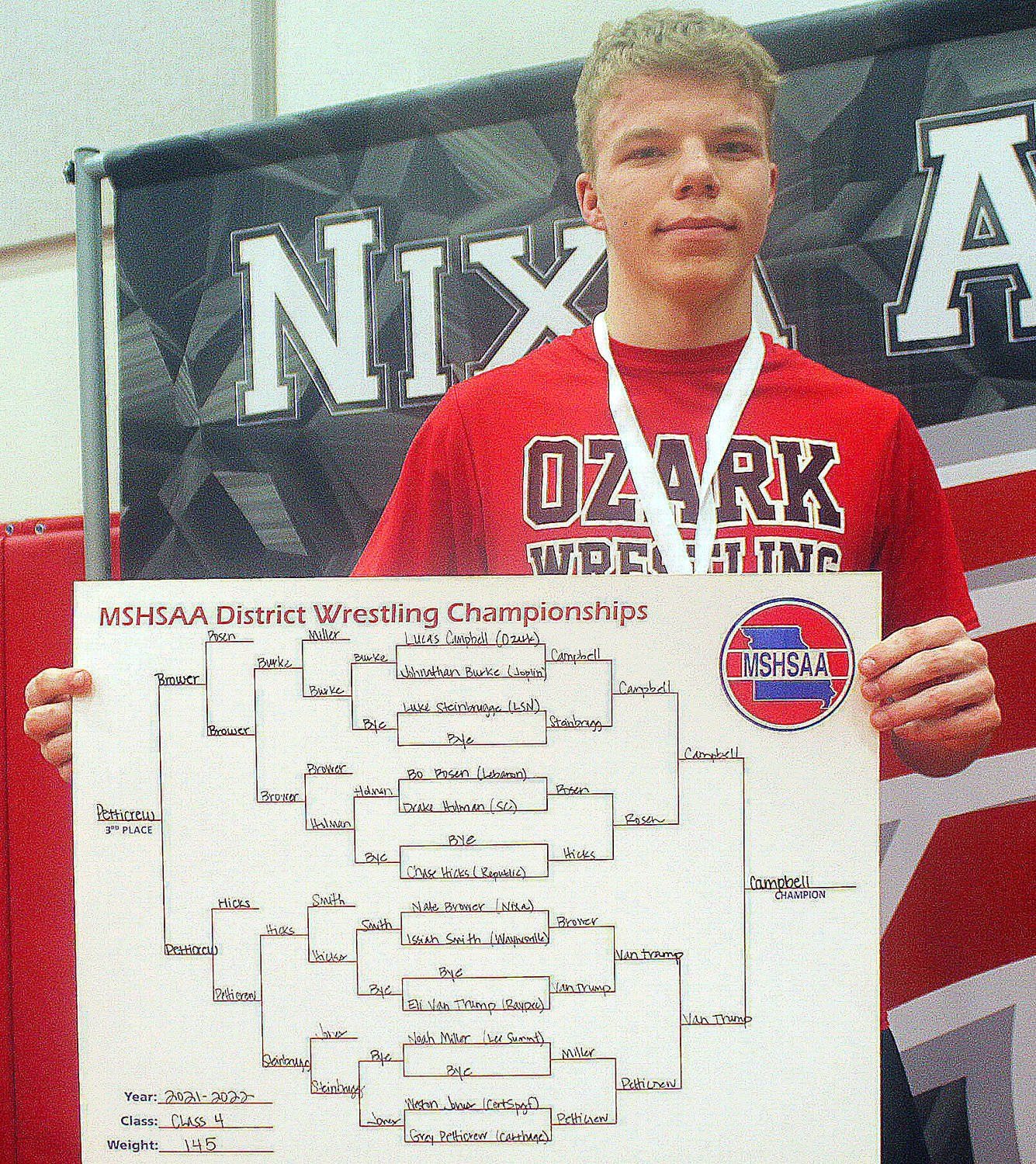 OZARK’S LUCAS CAMPBELL poses with his 145-pound bracket placard