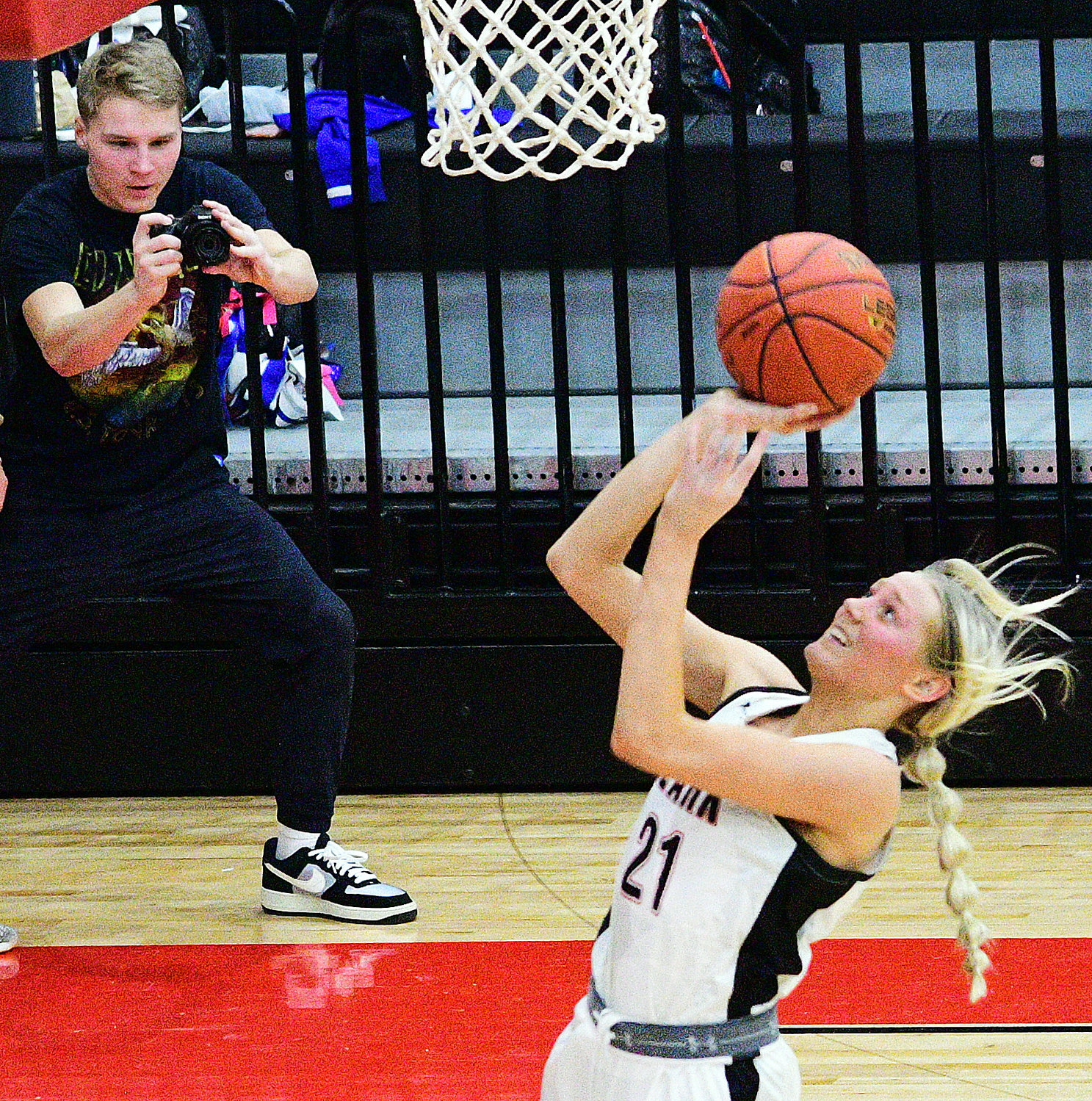 ZEFFIE KENT scores two of her 13 points as Ozark boys basketball player Nash Rodebush catches the action on his camera.