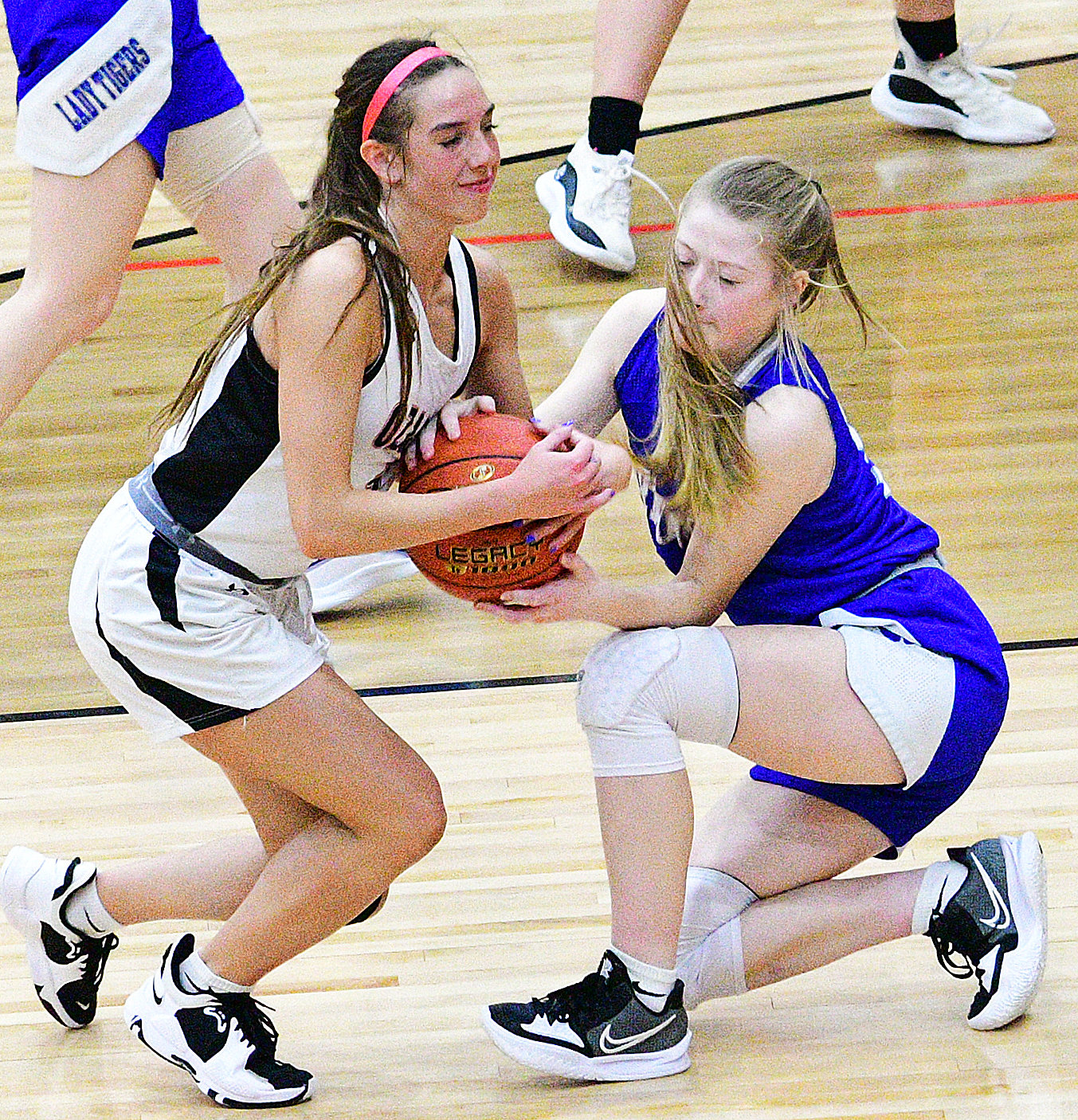 OZARK’S RILEY BOGGS battles a Carthage player for possession of the ball.