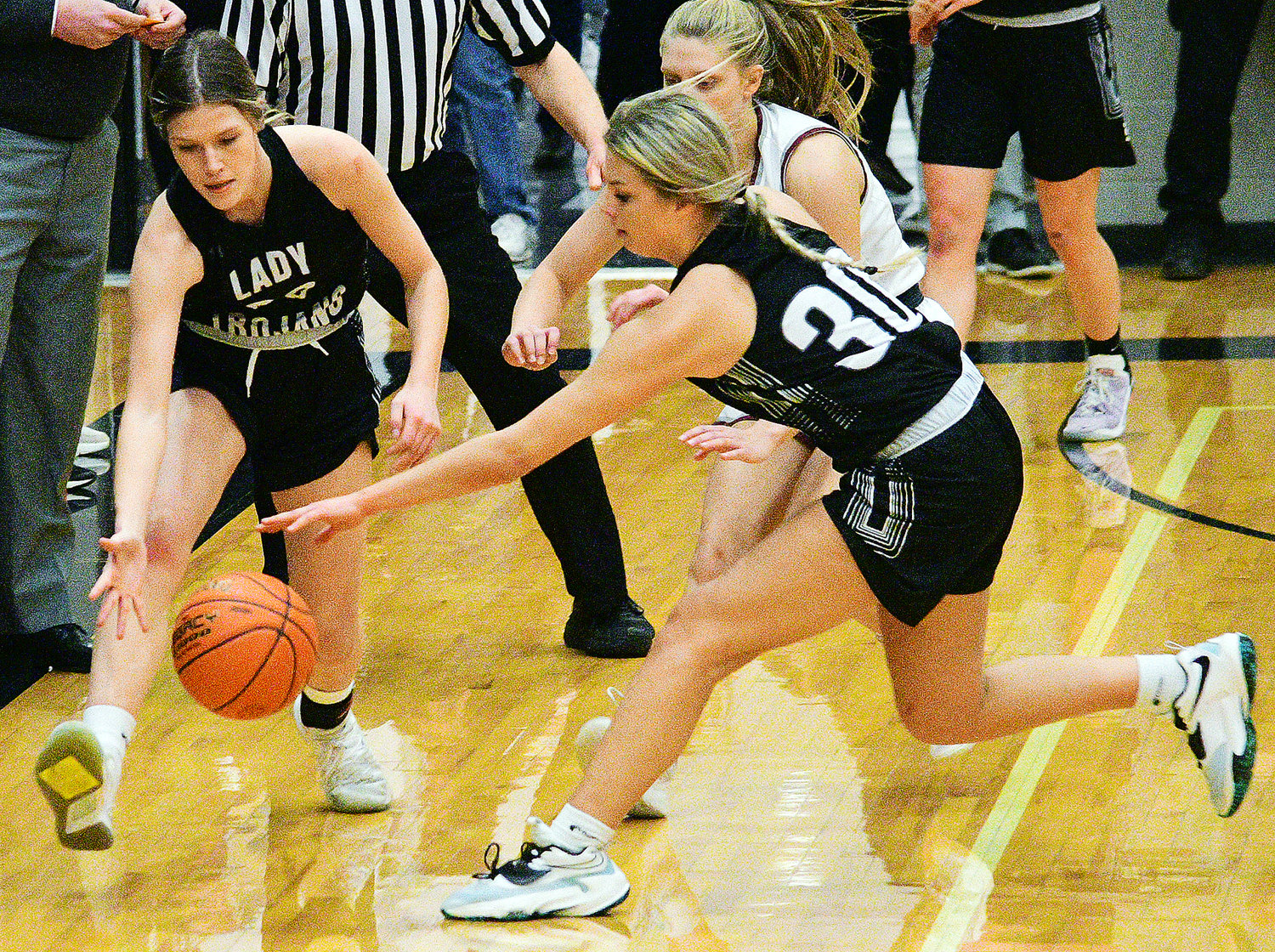 MEGAN BROWN AND BRYNN HOLT track down a loose ball.