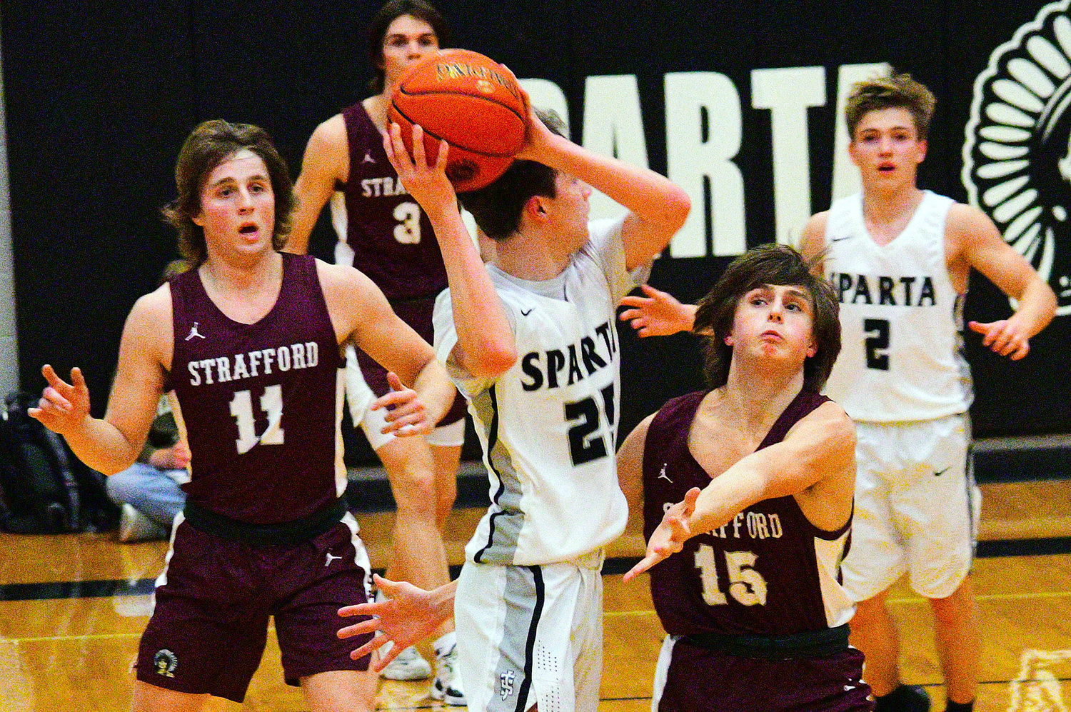 SPARTA'S MASON LETTERMAN looks to pass over Strafford defensive pressure Friday.
