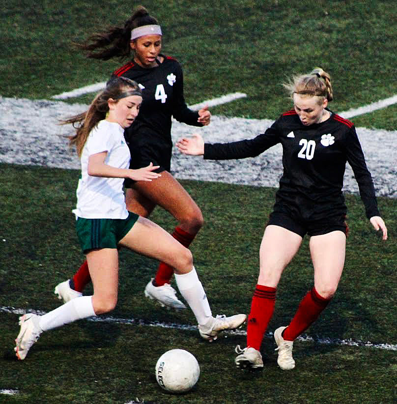OZARK’S AUDREY CARLTON AND HAYLE MALLONEE converge on a Catholic player.
