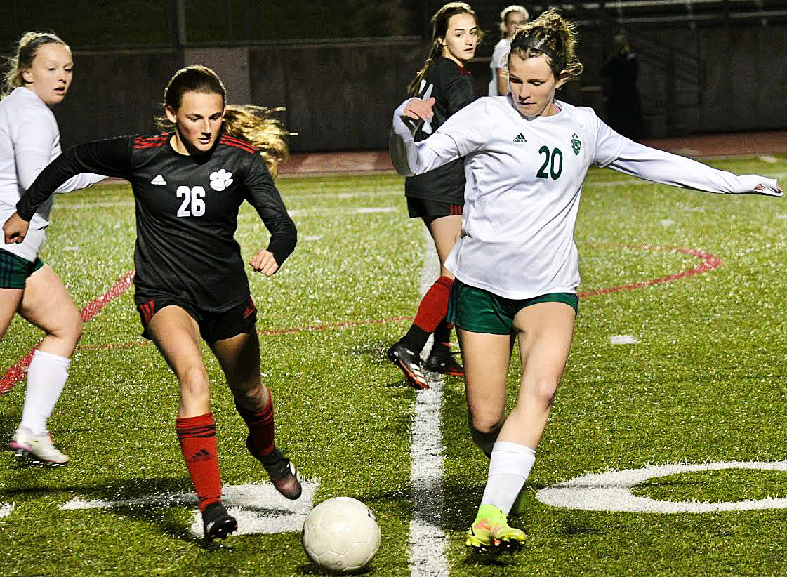 ADDIE SHULER and a Catholic player track down a loose ball.