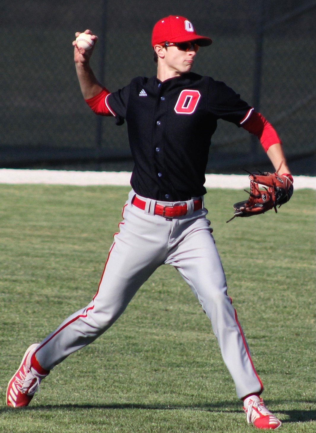 OZARK'S SUTTON HANKS returns the ball to the infield.