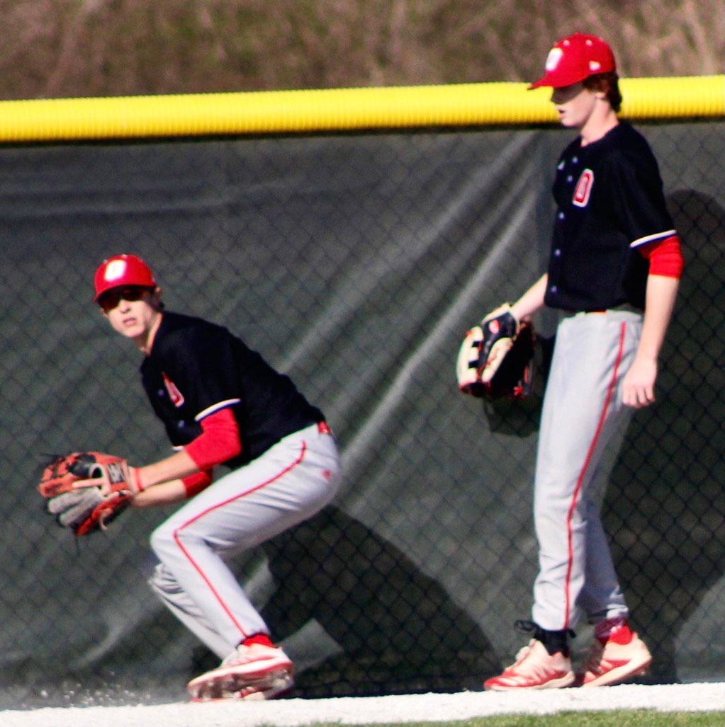 OZARK'S SUTTON HANKS tracks down a ball at the left-field fence.