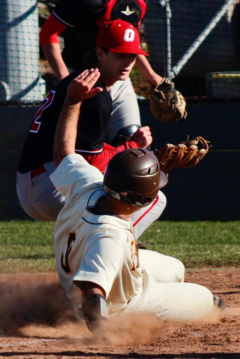 OZARK'S KANNON LITTLE makes a late tag at home plate.