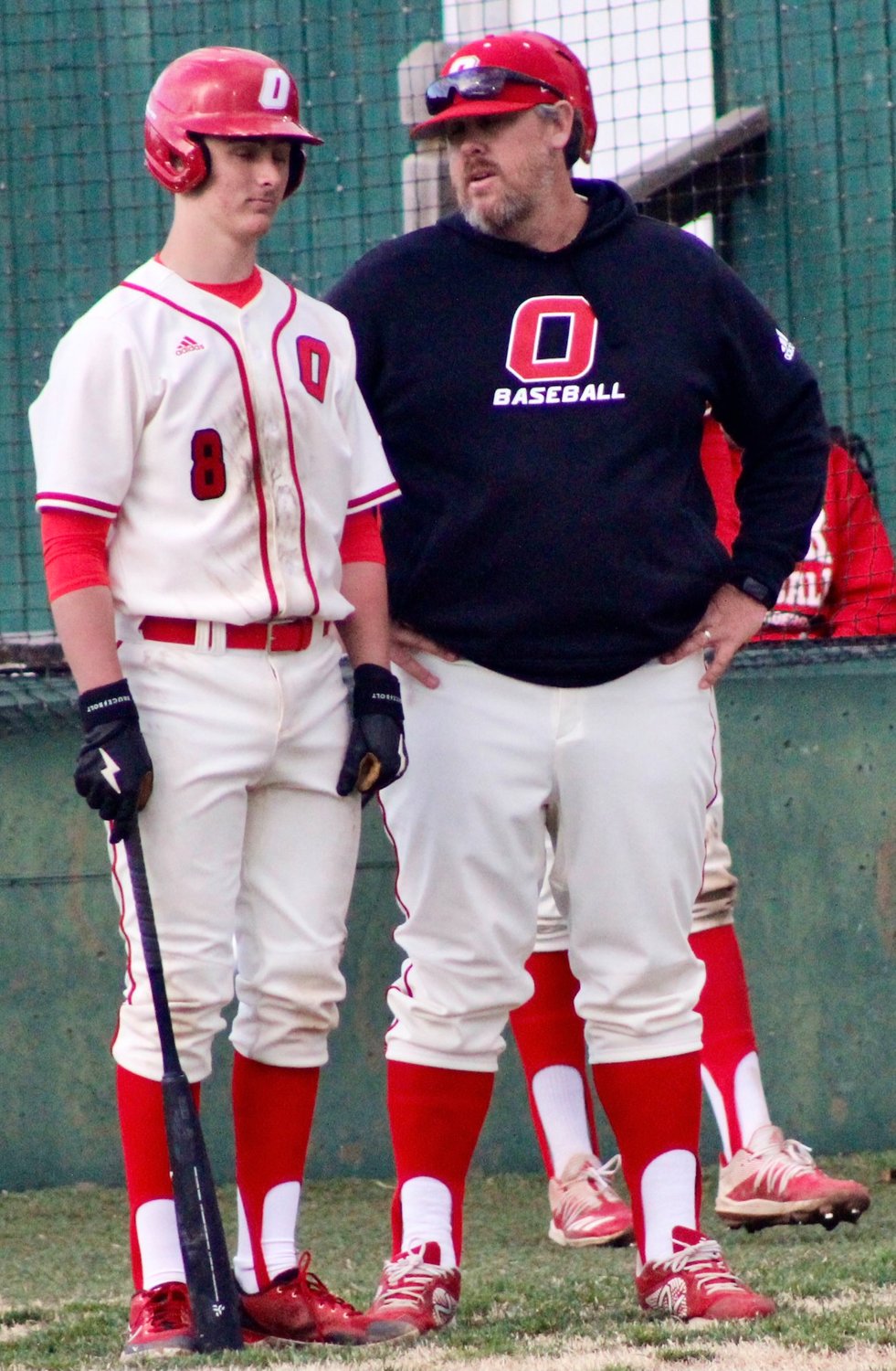 OZARK COACH JUSTIN SUNDLIE chats with catcher Cooper Buvid.