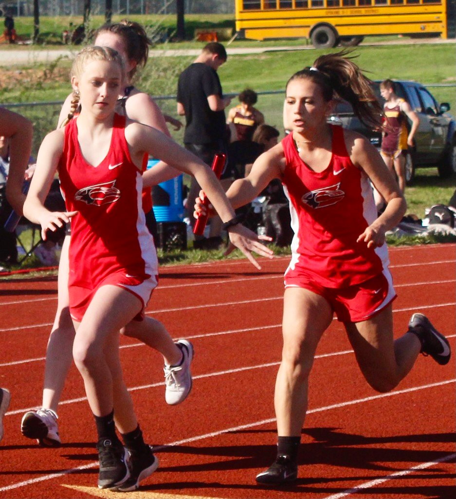 CHADWICK'S LILI CHILDRESS AND RACHEL HUME complete a handoff in the 4 x 200 relay.