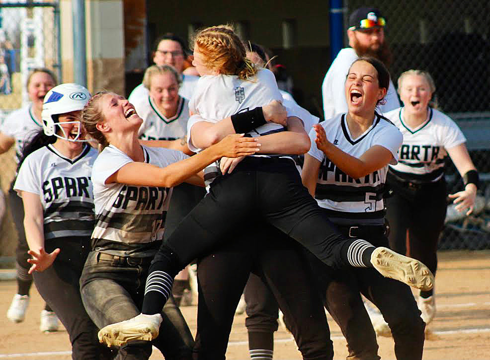 SPARTA'S MYA FULTON is mobbed by teammates after her game-winning hit in the Lady Trojans' 6-5 Class 2 District 5 semifinal win over Forsyth on Tuesday.