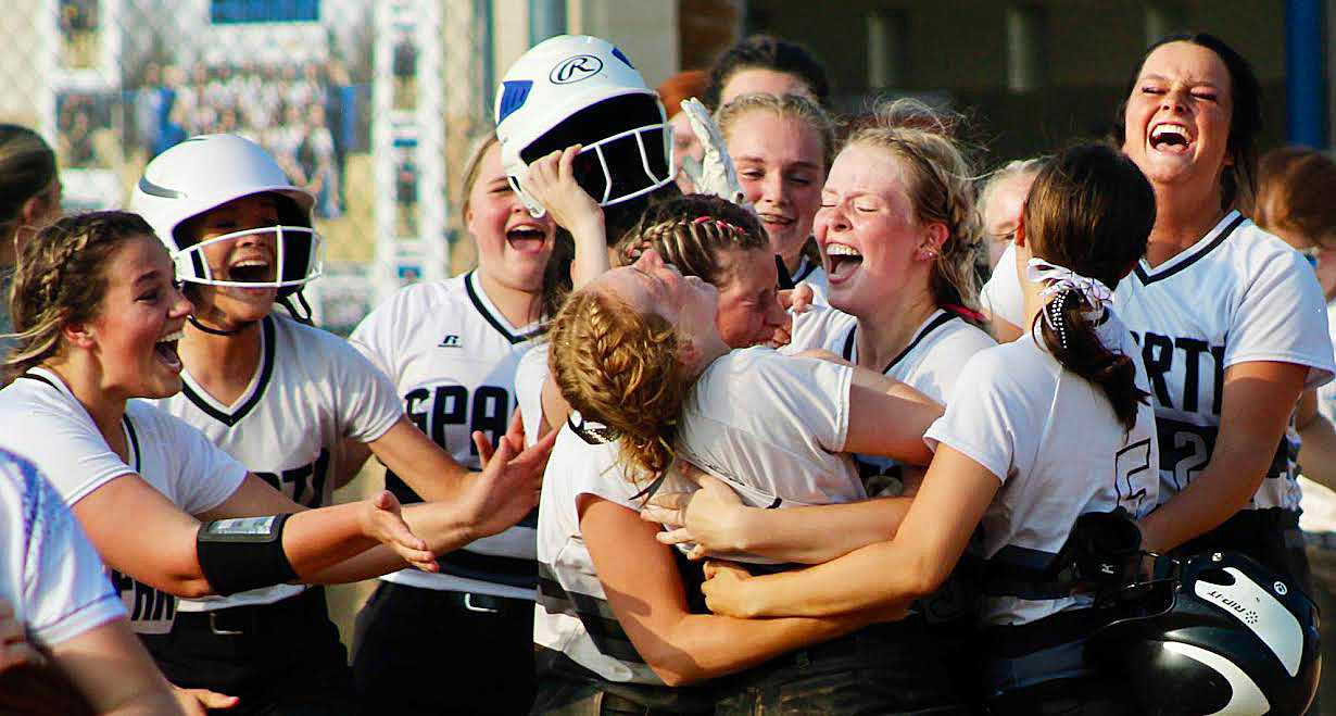 SPARTA'S MYA FULTON is mobbed by teamates.