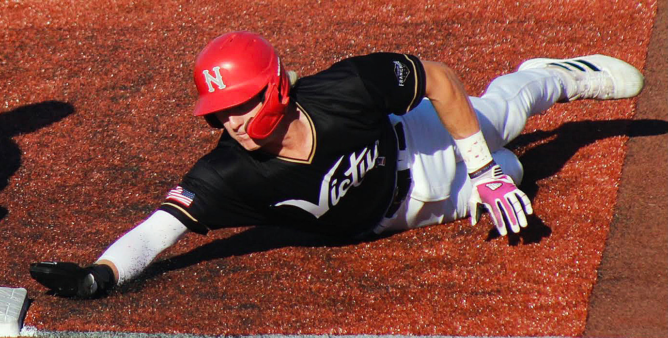 JARET NELSON dives back to first base during a Show-Me Collegiate League game.