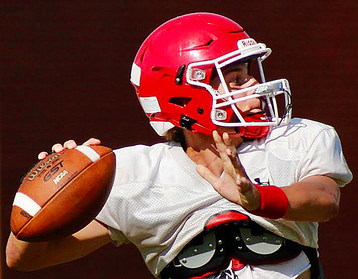 BRADY DODD prepares to throw downfield during Ozark’s summer camp workouts.