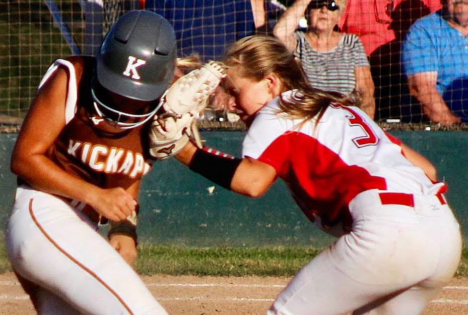 OZARK'S KELSIE BATEY tries to tag out a Kickapoo runner at second base.