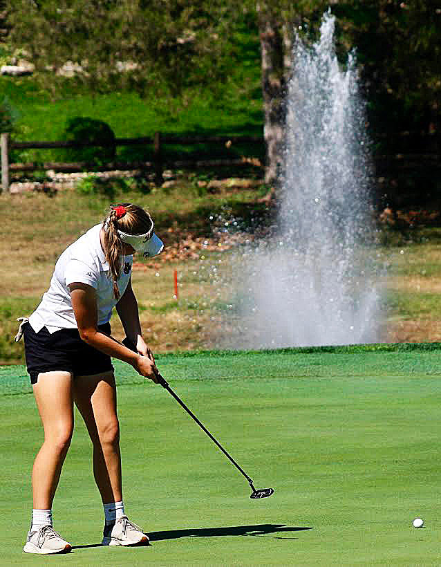 OZARK'S JOSEY ROBERTS watches her putt near the hole.