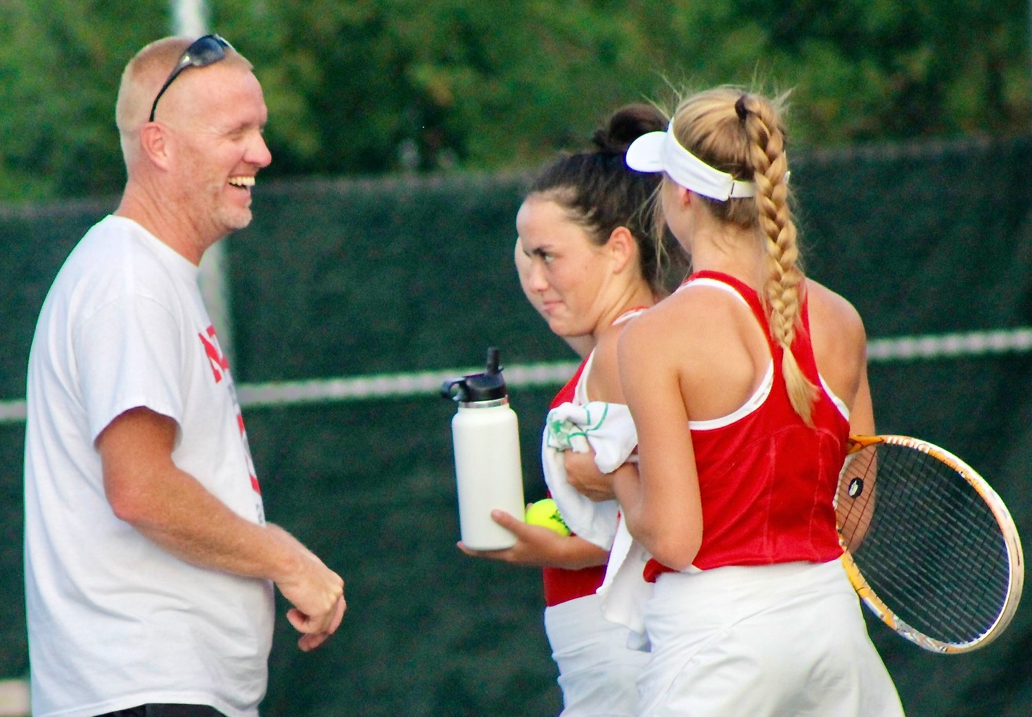NIXA COACH BROCK BLANSIt talks strategy with Sam Fulnecky and Ellie Sorgenfrei in between sets.