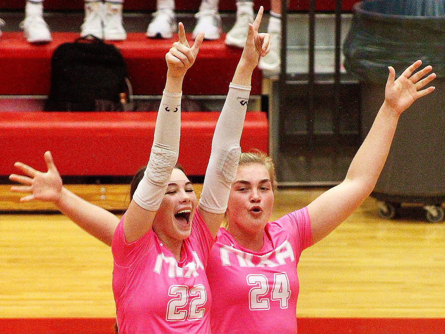 NIXA'S CHLOE JUDD AND CHRISTENA BERRY celebrate a Lady Eagles point Tuesday at Branson.