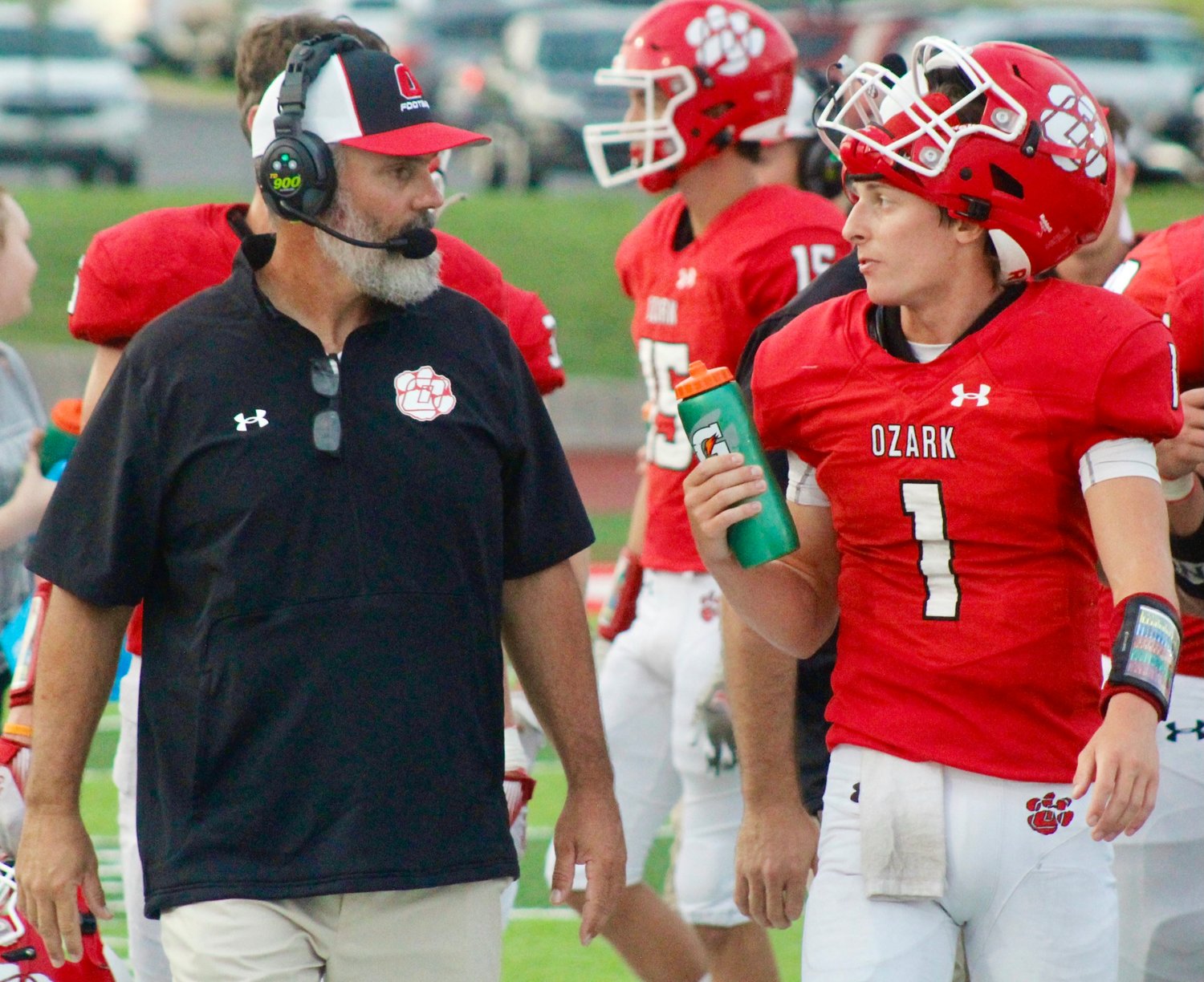 OZARK'S CHAD DEPEE, left, chats with QB Brady Dodd during the Tigers' 2-8 season this year.