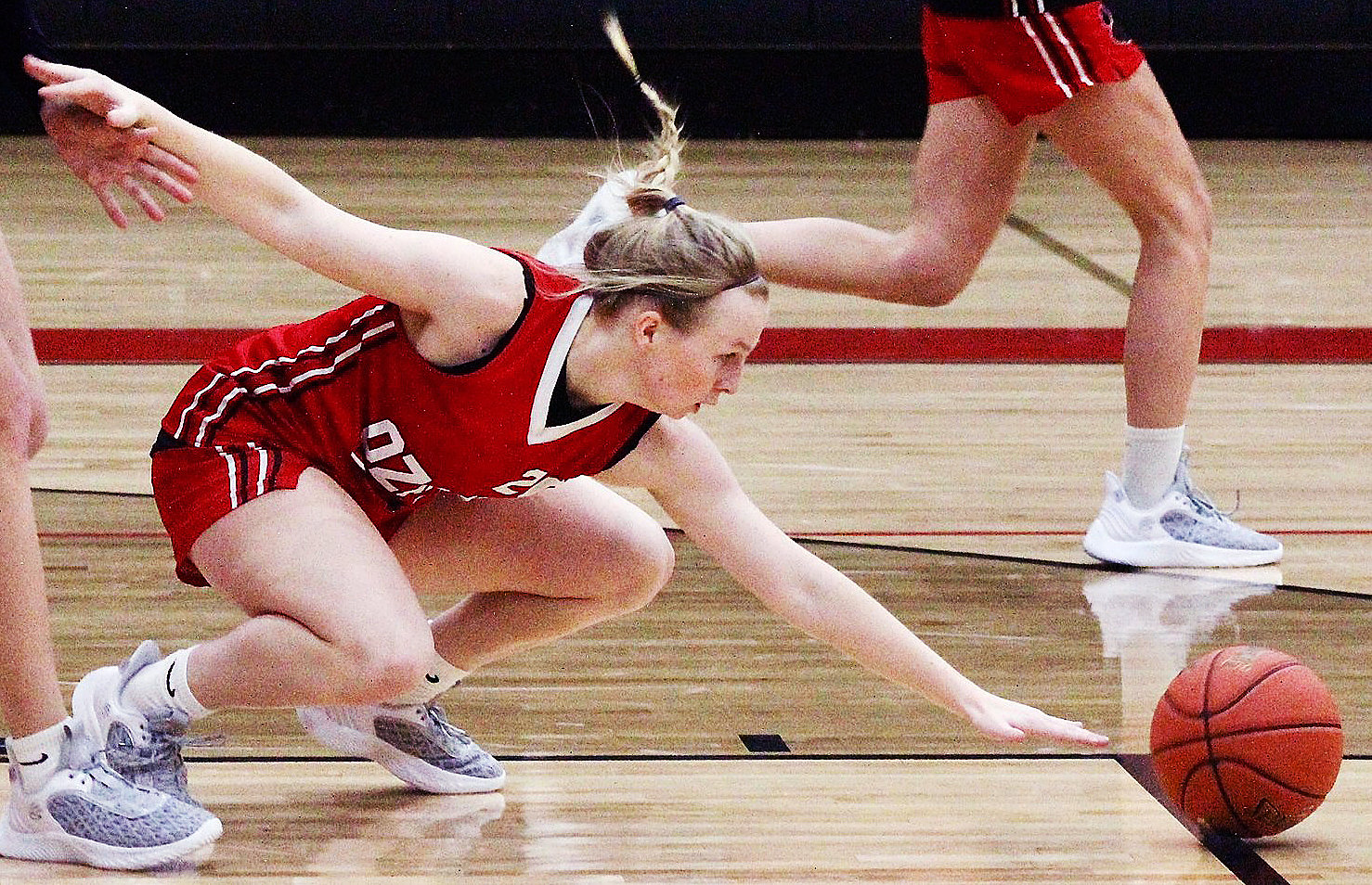 OZARK'S MOLLY RUSHING hits the floor while chasing after a loose ball during a Lady Tigers practice.
