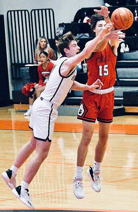 OZARK'S HUDSON ROBERTS reaches for the ball at mid-court.