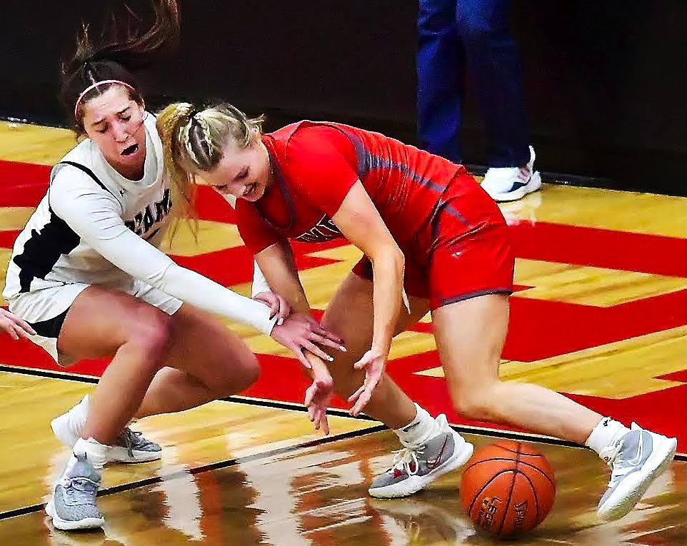 OZARKS SYDNEY HAMPTON AND NIXA'S JACY BRAY scramble for a loose ball.