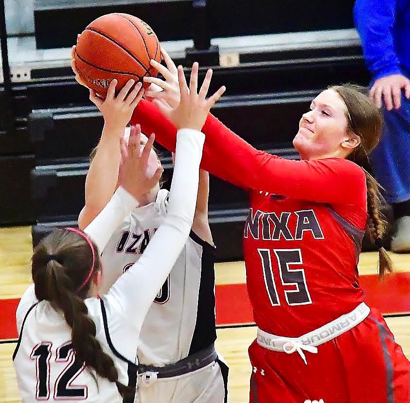 NIXA'S ALLISON JONES reaches for a rebound.