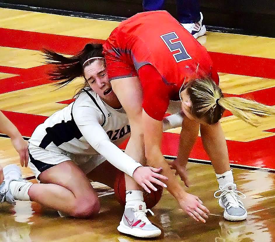 OZARK'S SYDNEY HAMPTON NIXA'S JACY BRAY battle for control of the ball.