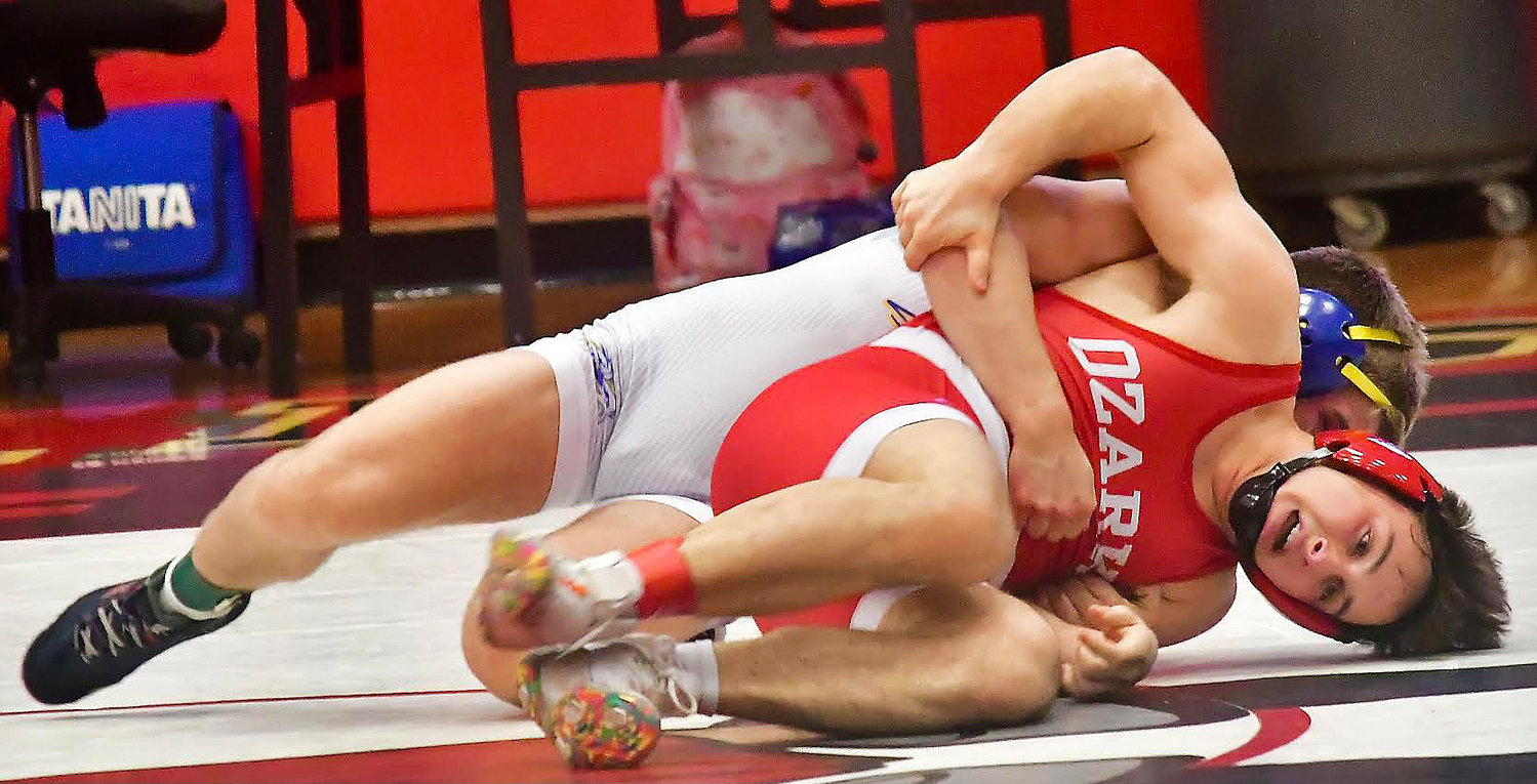 OZARK'S BRAXTON STRICK competes with Bolivar's Riley Beckman in the 157 final at the Branson Tournament on Saturday.