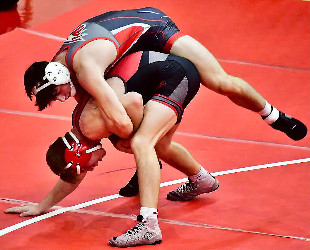 NIXA'S NATE BROWER climbs on the back of Ozark's Lucas Campbell,