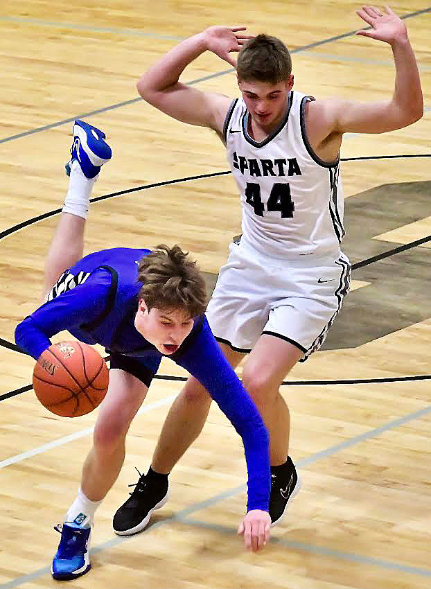 SPARTA'S DEXTER LOVELAND makes contact with a Greenwood player without drawing a foul.