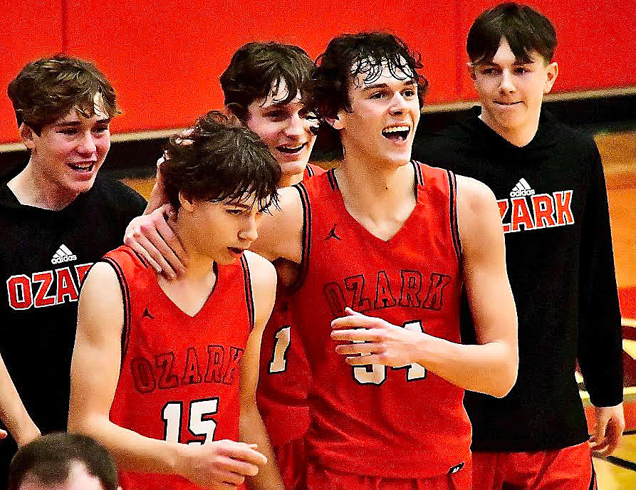 OZARK'S HUDSON ROBERTS is mobbed by teammates.