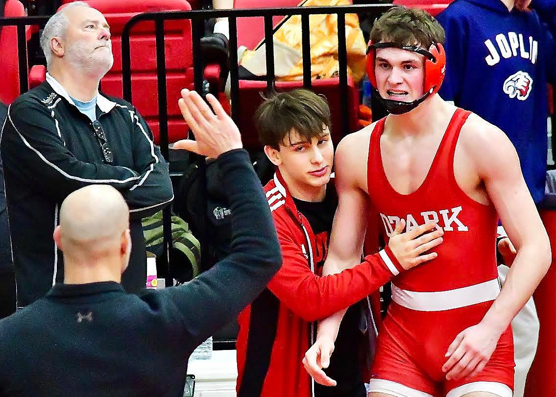 OZARK'S JOHNNY WILLIAMS receives glad hands after his semifinal win at 190 pounds in Class 4 District 3 action Saturday.