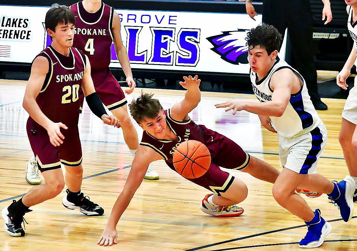 SPOKANE'S BO ESSICK dives for a loose ball against Greenwood on Monday.