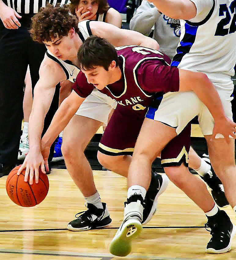 SPOKANE'S WILEY ARMITAGE fight for a loose ball.