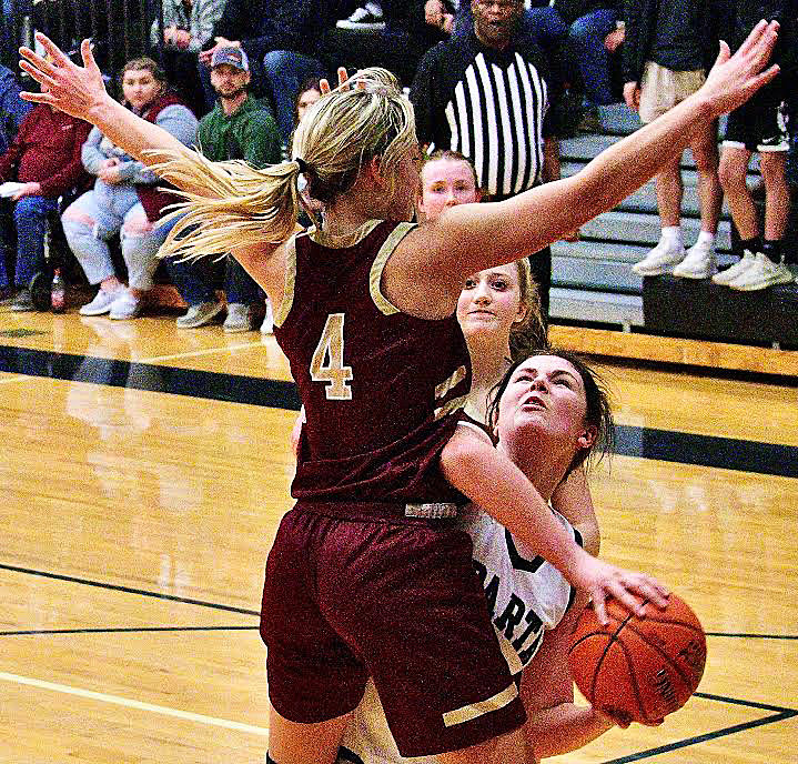 SPARTA'S AMREE YOUNGMON tries to find room to shoot while defended by Spokane's Sydney Bryan.