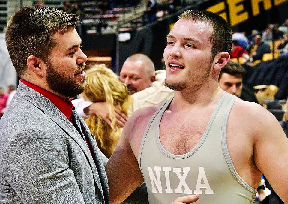 NIXA'S BRENNAN CAREY receives congrats for his Class 4 215-pound state championship.
