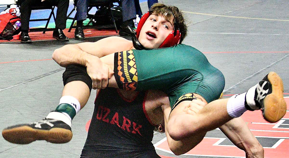 OZARK'S BRAXTON STRICK fights for position during a Class 4 150-pound semifinal Saturday.