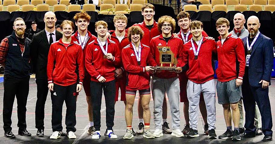 OZARK'S WRESTLING TEAM poses with their fourth-place trophy.