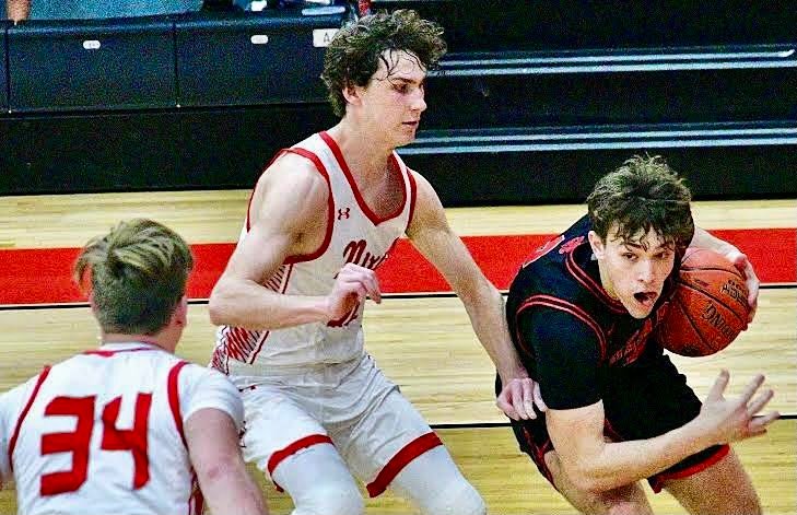 OZARK'S RYAN ENGEL drives along the baseline against Nixa on Wednesday.