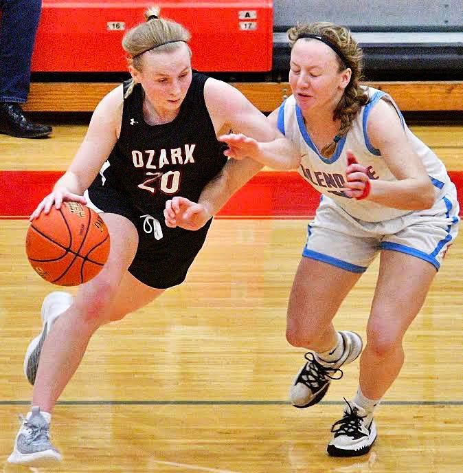 OZARK'S MOLLY RUSHING dribbles around a defender.