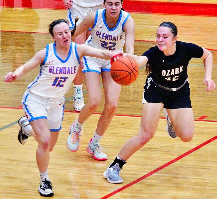 OZARK'S ALEXIS SOLOMAN and a Glendale player chase down a loose ball.