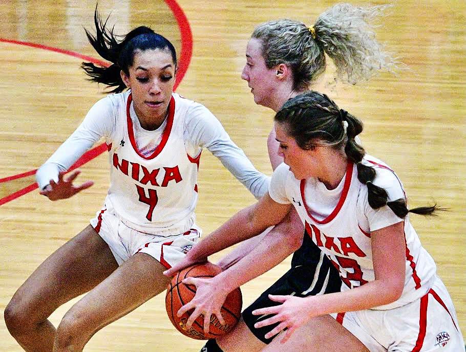 NIXA'S LAILA GRANT AND BROOKE TETER meet up with a Neosho ball-handler.