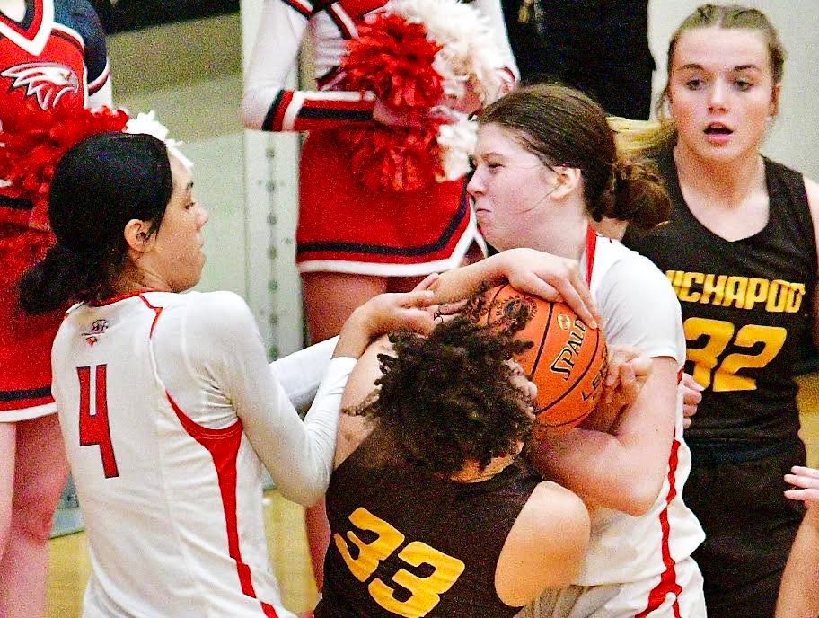 NIXA'S LAILA GRANT AND NORAH CLARK try to wrestle the ball away from a Kickapoo player.