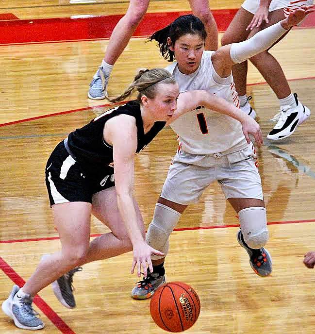 OZARK'S MOLLY RUSHING dribbles in in the paint.
