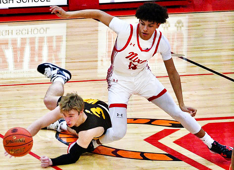 NIXA"S COREY KEMP and Kickapoo's Trae Oetting track down a loose ball during Monday's Class 6 District 5 final.