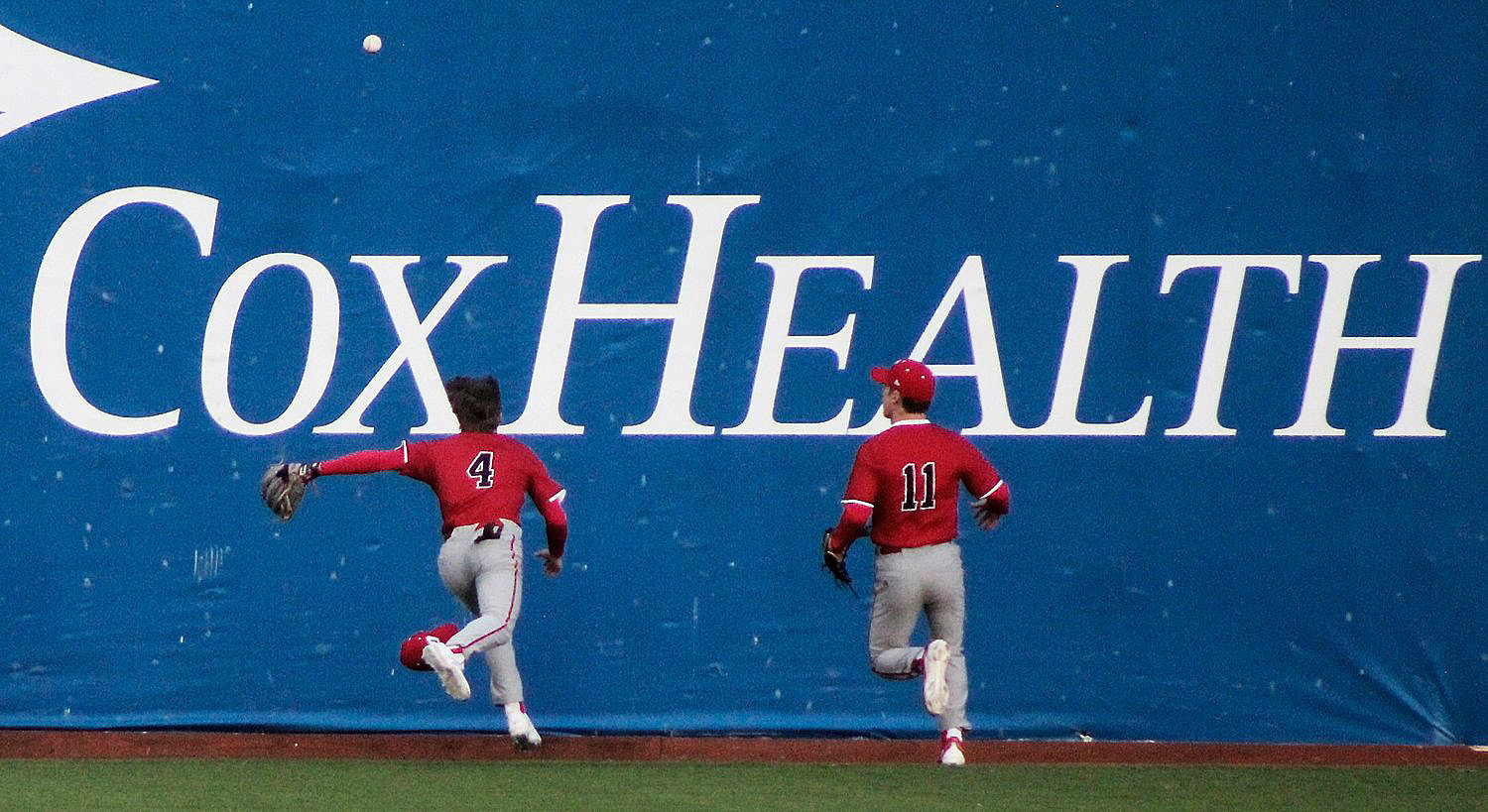 OZARK'S BROCK DODD AND BROCK SUNDLIE give chase to a fly ball.
