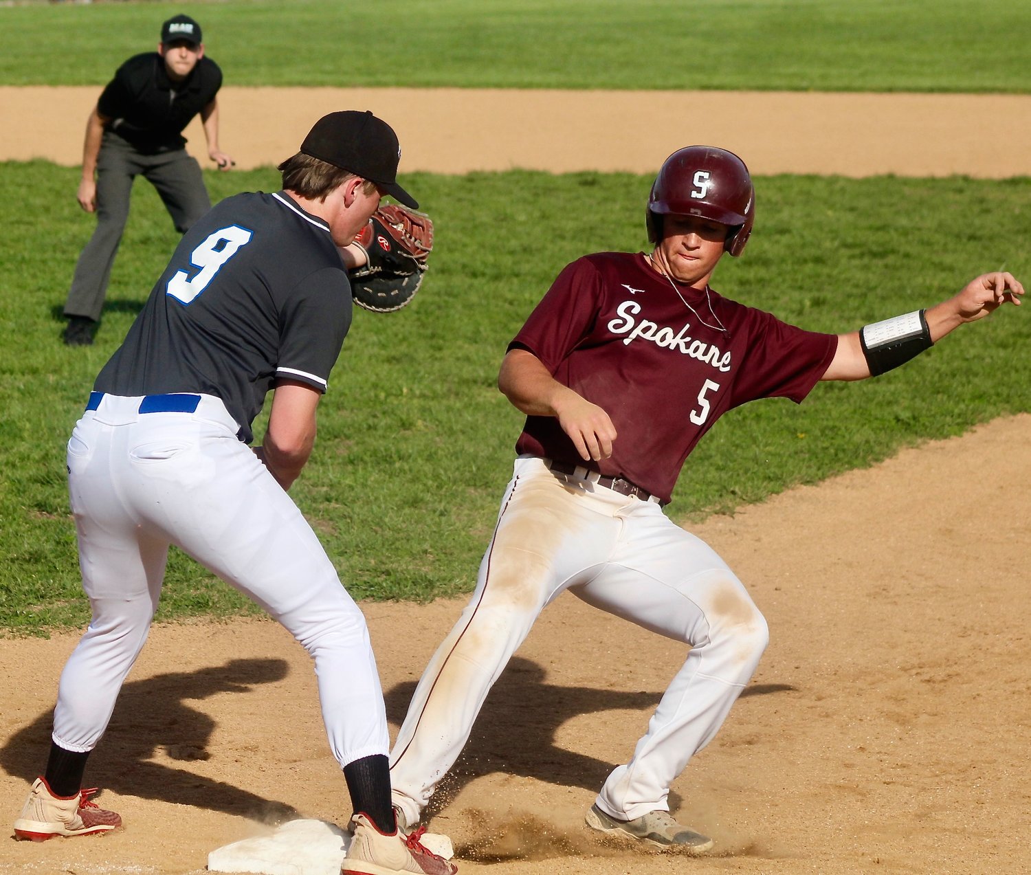 SPOKANE'S BO ESSICK gets back to first base safely.
