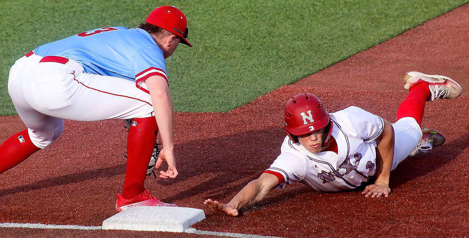 NIXA'S CAEDEN CLOUD dives back to first base on a pick-off attempt. He was called out on the play.